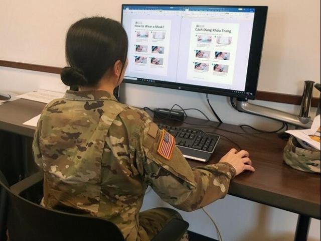 Behind a photo of a US intelligence officer translating the Covid-19 document into Vietnamese